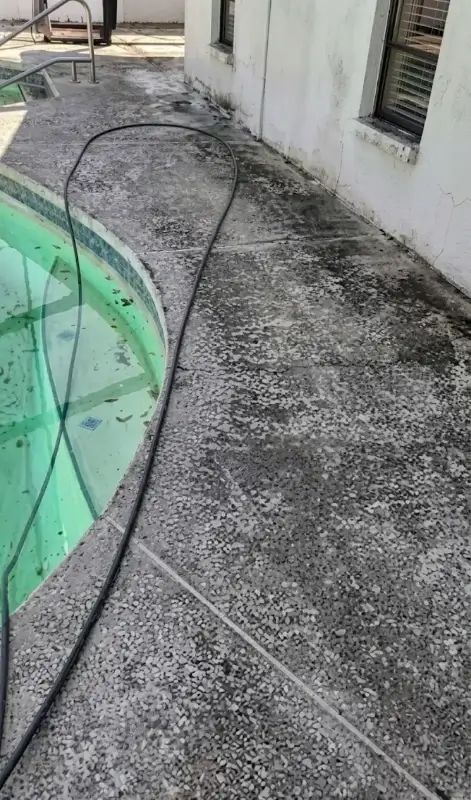 Slippery algae covered pool deck before cleaning